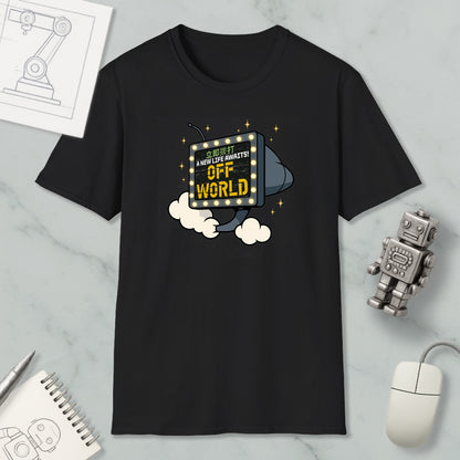 a black t-shirt with a graphic design depicting a robot or robot-like figure flying through the air with a sign that says "Off World". The t-shirt is displayed on a marble surface, along with a computer mouse, a notebook, and a small robot figurine.