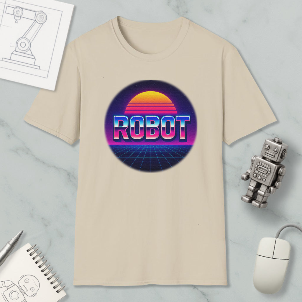 a beige t-shirt with a graphic design of a robot and a sunset, along with various office supplies such as a mouse, a notebook, and a pen.