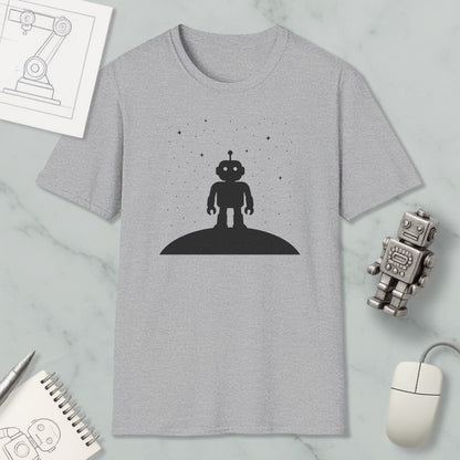 a gray t-shirt with a black silhouette of a robot standing on a hill, surrounded by stars, and a small robot figurine.