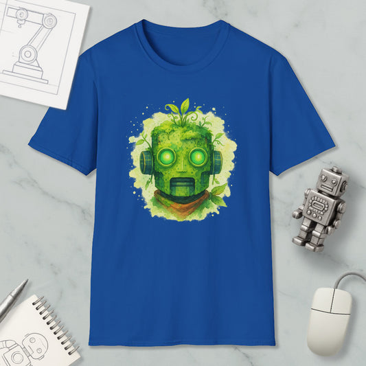 a blue t-shirt with a green robot-like face design, surrounded by various objects such as a computer mouse, a notebook, and a small robot figurine.