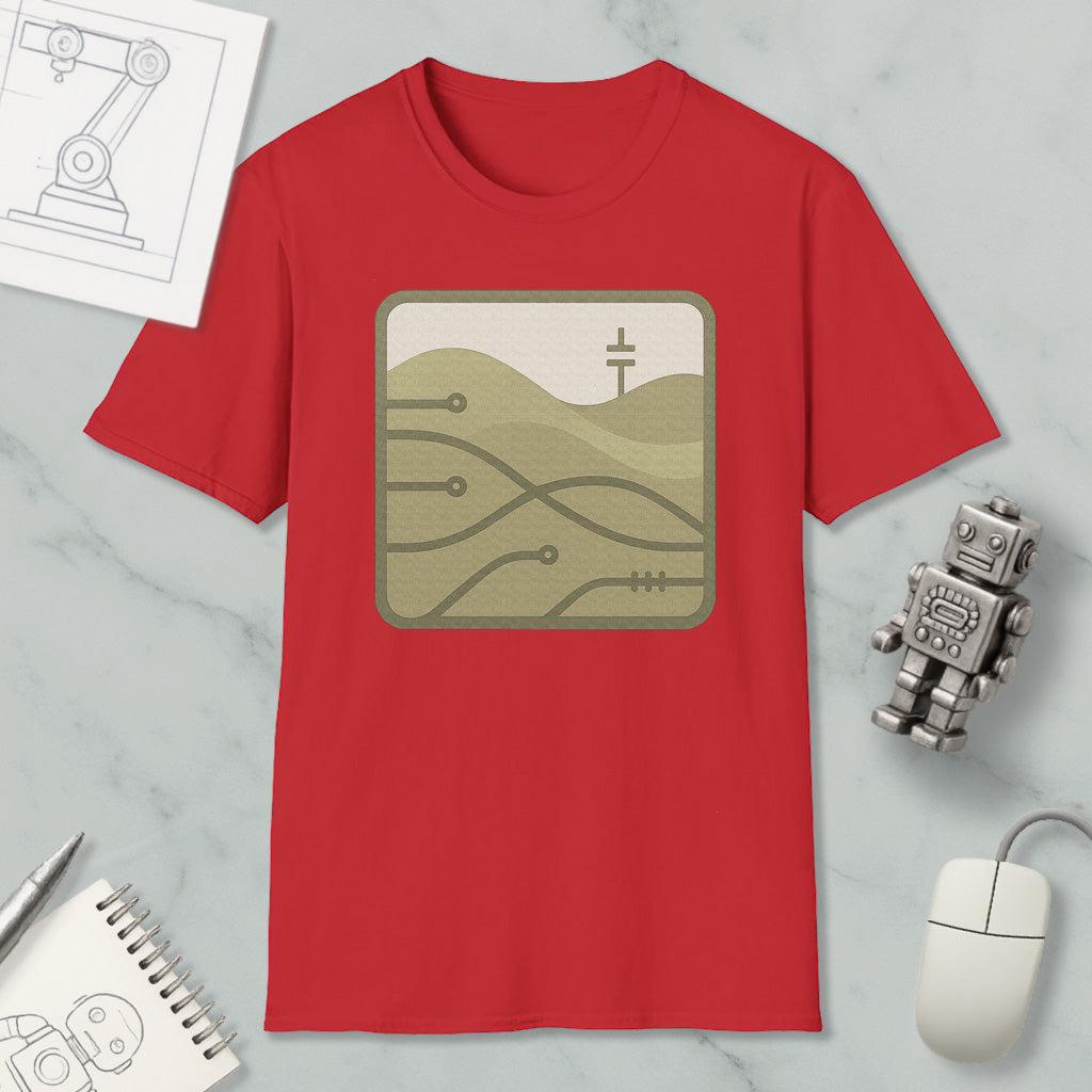 a red t-shirt with a graphic design, a computer mouse, a notebook, and a small robot on a marble surface.