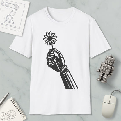 a white t-shirt with a black graphic design depicting a hand holding a flower, along with a computer mouse, a notebook, and a robot figurine.