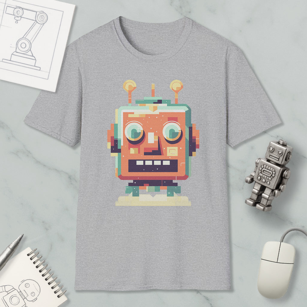 a gray t-shirt with a colorful robot graphic, along with various objects such as a computer mouse, a notebook, and a pen.