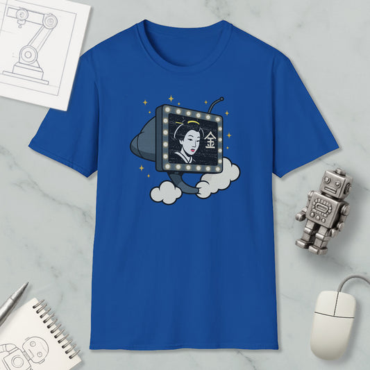 a blue t-shirt with a graphic design depicting a woman's face on a television screen, surrounded by clouds and stars. The t-shirt is placed on a marble surface, with a computer mouse and a robot figurine nearby.