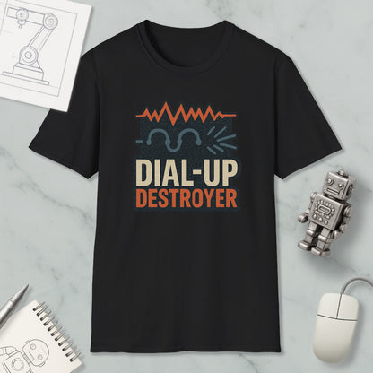 a black t-shirt with a graphic design that says "DIAL-UP DESTROYER" in orange and white text. The t-shirt is placed on a marble surface, along with a small robot toy and a computer mouse.