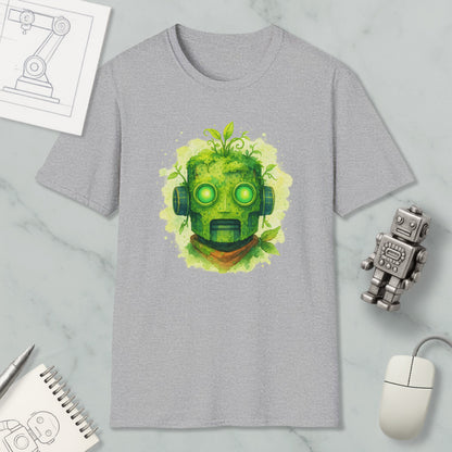 a gray t-shirt with a green robot-like face design, surrounded by various objects such as a computer mouse, a notebook, and a sketch of a machine.