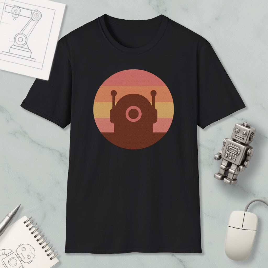 a black t-shirt with a circular graphic design on it, along with various objects such as a computer mouse, a notebook, and a robot figurine.