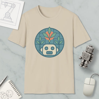 a beige t-shirt with a graphic design of a robot and plants, along with a computer mouse and a notebook on a marble surface.
