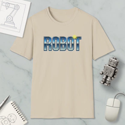 a beige t-shirt with the word "ROBOT" printed on it, along with a small robot toy and some other items such as a notebook and a mouse.