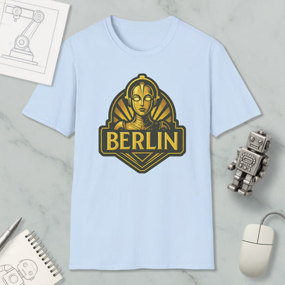 a light blue t-shirt with a graphic design of a robot or character, along with a computer mouse, a notebook, and a pen on a marble surface.