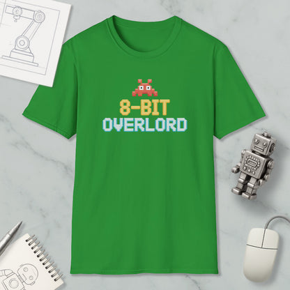 a green t-shirt with a pixelated character and text, along with various objects such as a computer mouse, a robot, and a notebook.