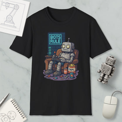 A black t-shirt with a graphic design depicting a robot sitting in a chair and holding a remote control, with the text "BOTS RULE" displayed above it.