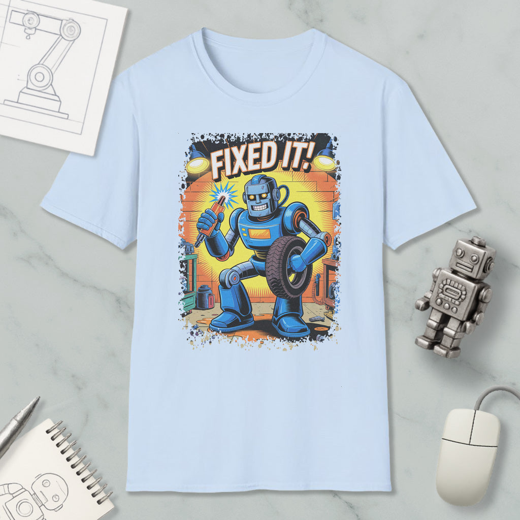 A light blue t-shirt with a graphic of a robot holding a wrench and the text "FIXED IT!"