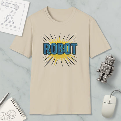 a beige t-shirt with a graphic design of the word "ROBOT" in blue and yellow colors, along with a yellow explosion-like design. The t-shirt is placed on a marble surface, and there are various objects such as a computer mouse, a notebook, and a small robot figurine nearby.