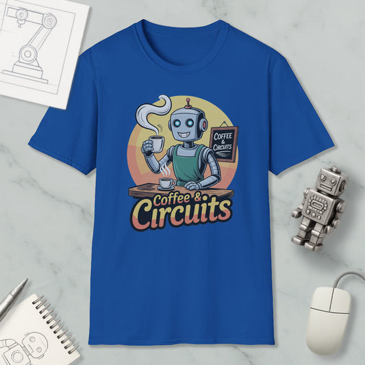 a blue t-shirt with a graphic design of a robot holding a cup of coffee and a sign that says "Coffee & Circuits". The t-shirt is displayed on a marble surface, along with a computer mouse, a notebook, and a small robot figurine.