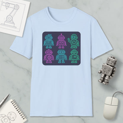 a light blue t-shirt with a graphic design of six colorful robot icons arranged in a square pattern. The t-shirt is placed on a marble surface, along with a computer mouse, a pen, and a notebook.