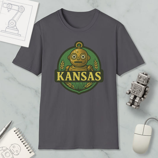 a gray t-shirt with a graphic design of a robot and the word "KANSAS" printed on it, along with a small robot figurine and a computer mouse.