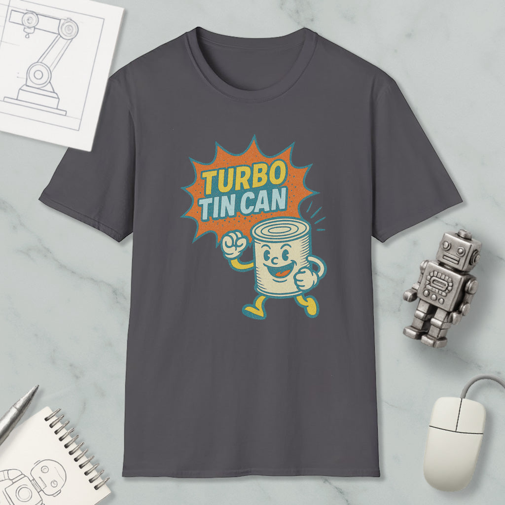 a gray t-shirt with a graphic design depicting a tin can character with a surprised expression, accompanied by the text "TURBO TIN CAN". The t-shirt is displayed on a marble surface, along with a computer mouse, a notebook, and a small robot figurine.
