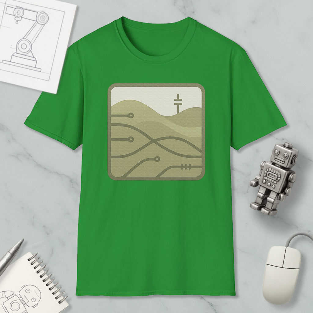 a green t-shirt with a graphic design, a small robot, a computer mouse, and some sketches or drawings on a marble surface.