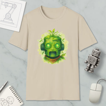 a beige t-shirt with a green robot-like face design, surrounded by various objects such as a computer mouse, a notebook, and a small robot figurine.