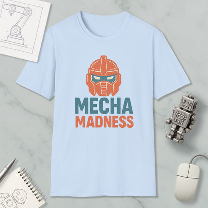 a light blue t-shirt with a graphic design of a robot's head and the text "MECHA MADNESS" printed on it, along with a computer mouse and a notebook.