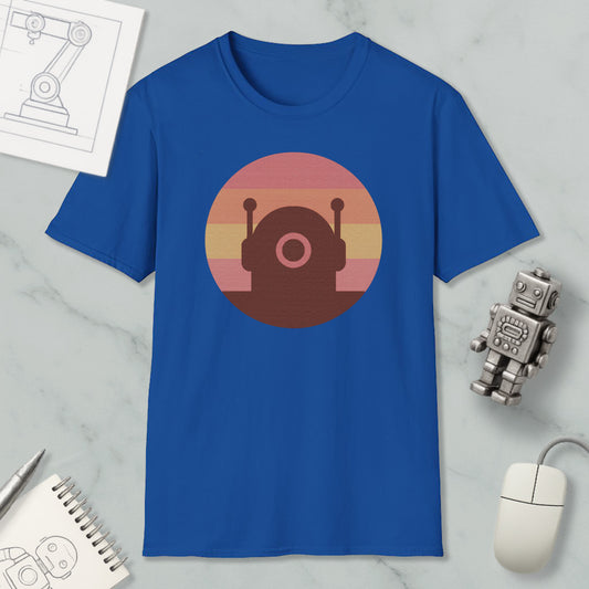 a blue t-shirt with a circular graphic design, a small robot figurine, a computer mouse, and a notebook on a marble surface.