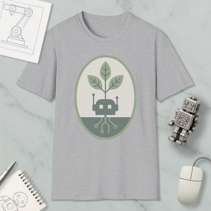 a gray t-shirt with a green and white graphic design, a small robot, a computer mouse, and a notebook on a marble surface.