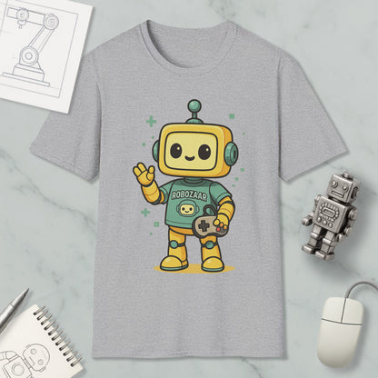 a gray t-shirt with a cartoon robot character wearing a green shirt and holding a game controller. The t-shirt is displayed on a marble surface, along with a computer mouse, a pen, and a notebook.