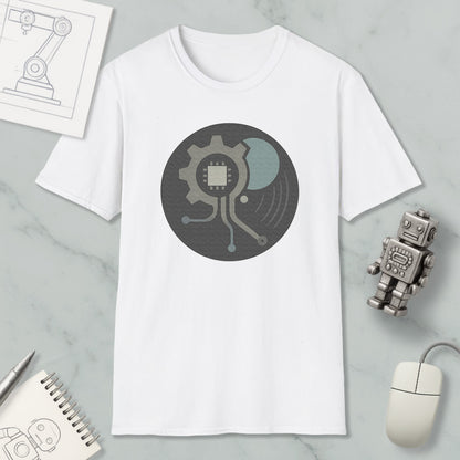 a white t-shirt with a graphic design, a small robot, a computer mouse, and a notebook on a marble surface.
