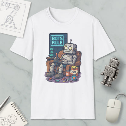 A white t-shirt with a graphic design depicting a robot sitting in a chair and playing a video game, with the text "BOTS RULE" displayed above the robot.