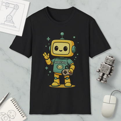 a black t-shirt with a cartoon robot character wearing a green shirt and holding a game controller. The t-shirt is displayed on a marble surface, along with a computer mouse, a notebook, and a small robot figurine.