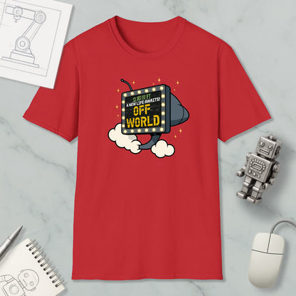 a red t-shirt with a graphic design, a computer mouse, a notebook, and a robot figurine on a marble surface.