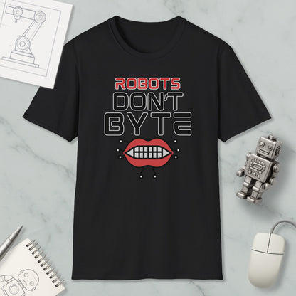 a black t-shirt with a graphic design that says "ROBOTS DON'T BYTE" and includes a graphic of a robot's mouth with teeth. The t-shirt is placed on a marble surface, along with a computer mouse, a notepad, and a small robot figurine.