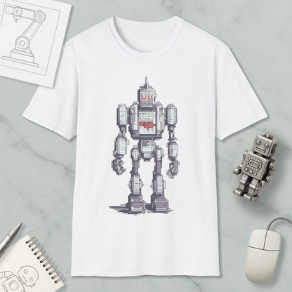 a white t-shirt with a pixelated robot design, along with various objects such as a computer mouse, a notebook, and a pen.