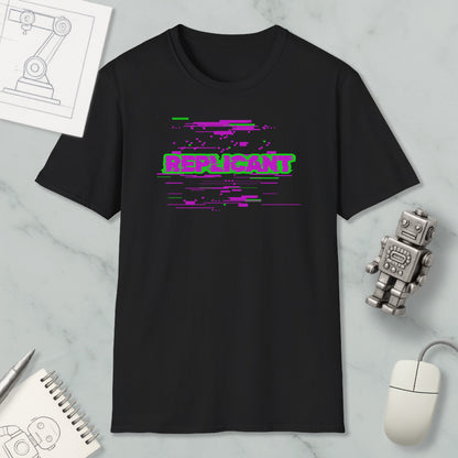 a black t-shirt with a graphic design, a computer mouse, a notebook, and a small robot figure on a marble surface.
