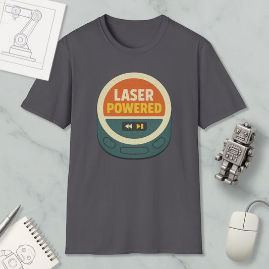 a gray t-shirt with a graphic design that says "LASER POWERED" in bold letters, surrounded by a circular shape with a play button and a speaker icon. The t-shirt is displayed on a marble surface, along with a small robot toy and a computer mouse.