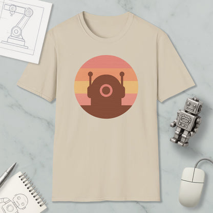 a beige t-shirt with a circular graphic design, a small robot, a computer mouse, and a notebook on a marble surface.