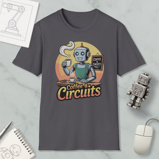 a gray t-shirt with a graphic design depicting a robot holding a cup of coffee and a sign that says "Coffee & Circuits". The t-shirt is displayed on a marble surface, along with a computer mouse, a notebook, and a small robot figurine.
