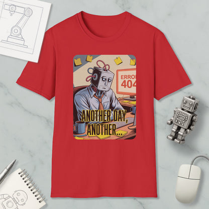 a red t-shirt with a graphic design depicting a robot or robot-like figure sitting at a desk with a computer, surrounded by various objects such as a mouse, a pen, and a notebook.