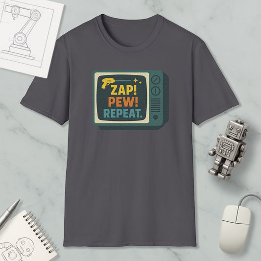 a gray t-shirt with a colorful graphic design, a computer mouse, a notebook, and a small robot on a marble surface.