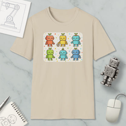a beige t-shirt with a colorful graphic of six cartoon robots, each with a unique color and design. The t-shirt is displayed on a marble surface, along with a computer mouse, a pen, and a notebook.