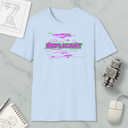 a light blue t-shirt with a graphic design, a computer mouse, a spiral notebook, and a small robot figurine.