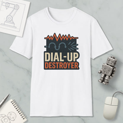 a white t-shirt with a graphic design, a computer mouse, a notebook, and a small robot on a marble surface.