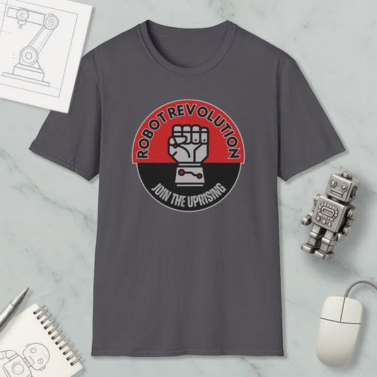 a gray t-shirt with a graphic design that says "Robot Revolution" and "Join the Uprising", along with a fist symbol. The t-shirt is displayed on a marble surface, surrounded by various objects such as a computer mouse, a notebook, and a robot figurine.