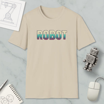 a beige t-shirt with the word "ROBOT" printed on it, along with a small robot toy and some other items such as a notebook and a mouse.