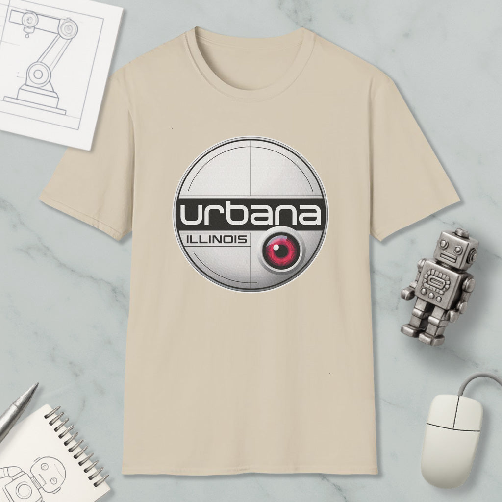 a beige t-shirt with a circular logo, a computer mouse, a robot, and some papers on a marble surface.