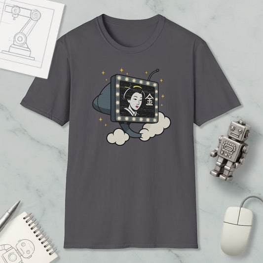a gray t-shirt with a graphic design depicting a woman's face inside a television set, surrounded by clouds and stars. The t-shirt is placed on a marble surface, with a computer mouse, a notebook, and a robot figurine nearby.