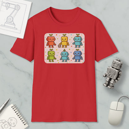 a red t-shirt with a colorful graphic of six cartoon robots, each with a unique design and color. The t-shirt is displayed on a marble surface, along with a computer mouse, a pen, and a notebook.
