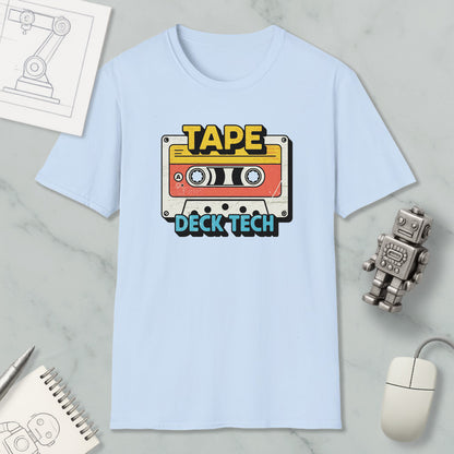 a light blue t-shirt with a graphic design of a cassette tape and the text "TAPE Deck Tech" printed on it, along with a small robot and a computer mouse.