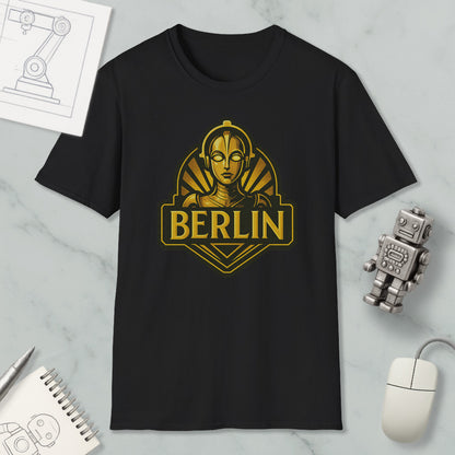 a black t-shirt with a graphic design of a woman's face and the word "BERLIN" printed on it, along with various objects such as a computer mouse, a notebook, and a robot.